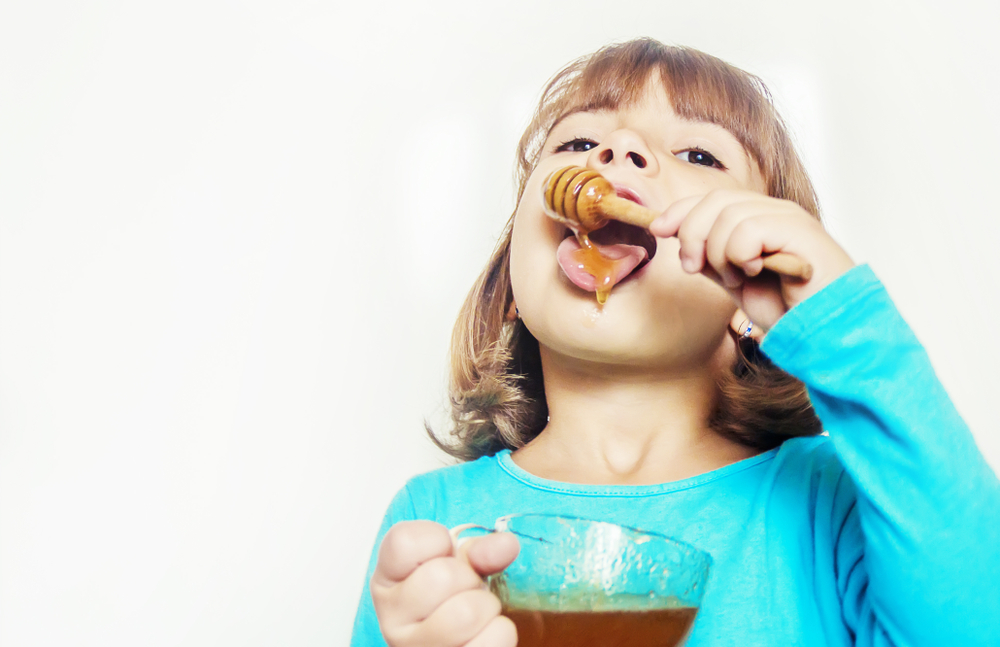 The,Child,Eats,Honey.,Selective,Focus.,Nature,Food