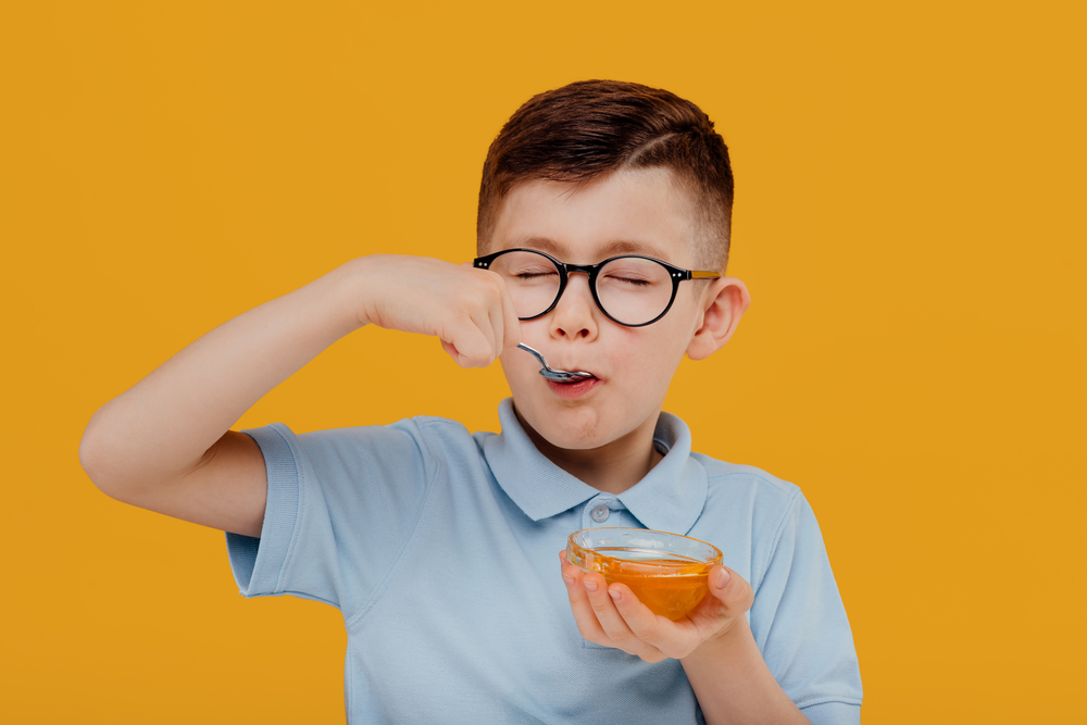 Happy,Little,Kid,Boy,In,Glasses,Smiling,And,Eating,Fresh