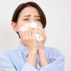 Asian,Middle,Aged,Woman,Blow,Her,Nose,In,White,Background